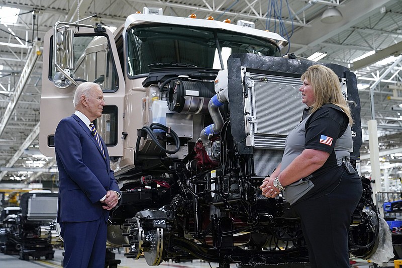 President Joe Biden listens as Tammy Flower, team manager, speaks as he tours the Lehigh Valley operations facility for Mack Trucks in Macungie, Pa., Wednesday, July 28, 2021. (AP Photo/Susan Walsh)