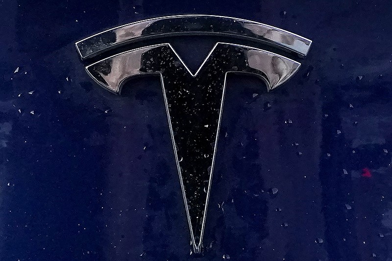 FILE - A Tesla electric vehicle emblem is affixed to a passenger vehicle, Feb. 21, 2021, in Boston. Tesla's summertime deliveries of electric vehicles surged 27% from last year but still fell below analyst projections as Elon Musks car company navigated through softening customer demand as well as factory upgrades. The Austin, Texas, automaker said Monday, Oct. 2, 2023 it sold 435,059 vehicles during the July-to-September period, up from 343,830 at the same time last year. (AP Photo/Steven Senne, file)