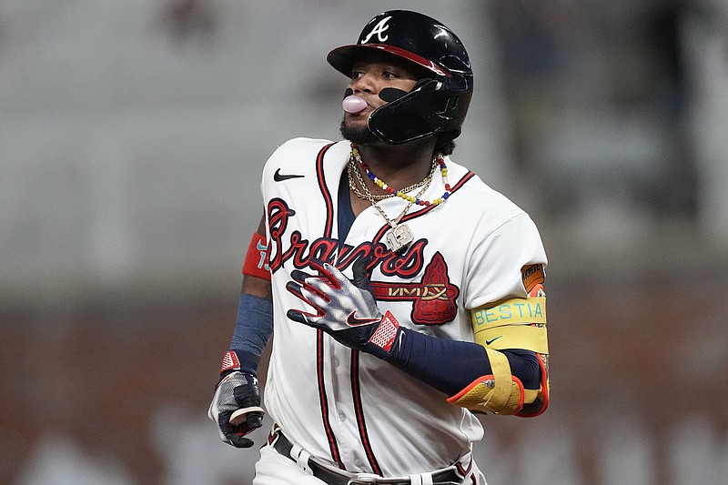 Atlanta Braves' Ronald Acuna Jr. (13) blows a bubble as he runs the bases after hitting a two-run home run in the seventh inning of a baseball game against the Chicago Cubs, Tuesday, Sept. 26, 2023, in Atlanta. (AP Photo/John Bazemore)