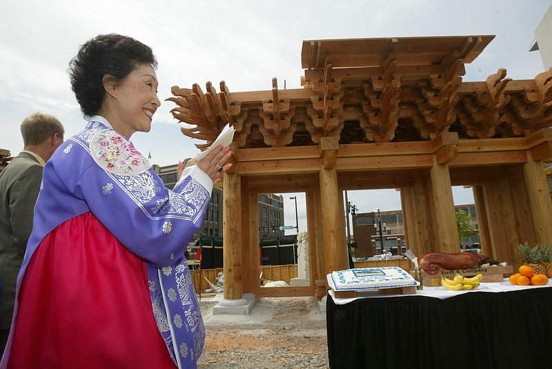American Taekwondo Association Chairman of the Board Sun C. Lee applauds the conclusion of a construction ceremony June 23, 2006, at the H.U. Lee International Gate and Garden adjacent to the Statehouse Convention Center. (Democrat-Gazette file photo/Staton Breidenthal)