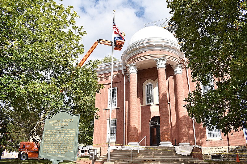 Democrat photo/Garrett Fuller — Tony Karch, of Imhoff Construction, rolls a fresh coat of white paint onto the portico roof Friday on the Moniteau County Courthouse. Imhoff Construction, of Jamestown, is a painting subcontractor for GBH Builders, a Jefferson City general contractor that has been replacing the 1868 facility's roof as the first of many renovation projects to improve the courthouse using American Rescue Plan Act funds.