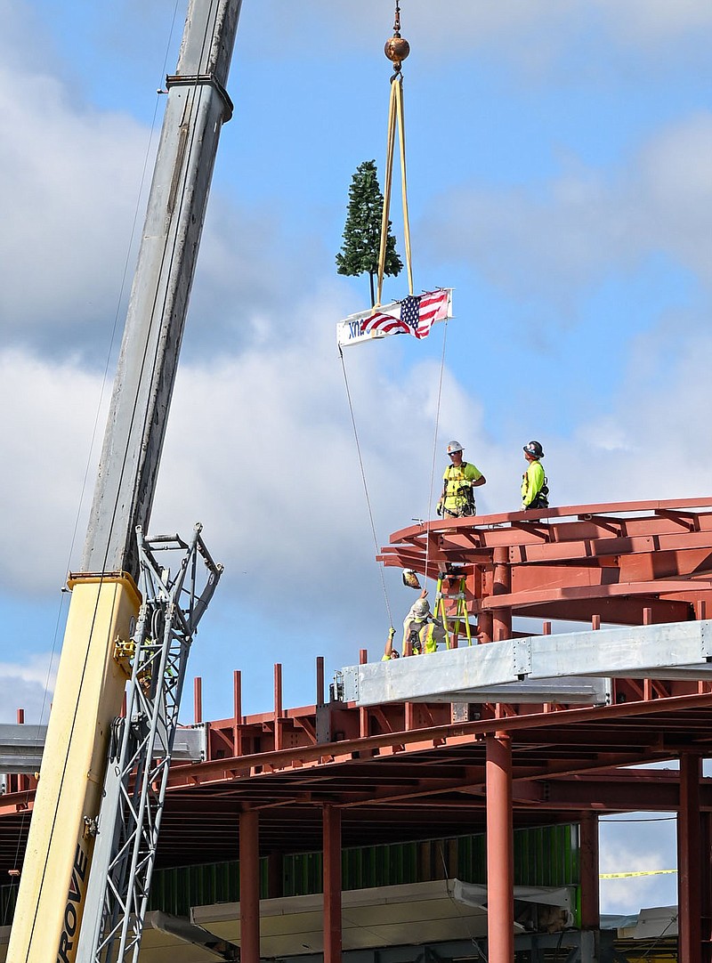 Nabholz construction workers place the final beam Thursday during at topping out ceremony for the terminal modernization project at Northwest Arkansas National Airport. The project will bring a variety of upgrades to the terminal. Visit nwaonline.com/photo for todays photo gallery.

(NWA Democrat-Gazette/Caleb Grieger)