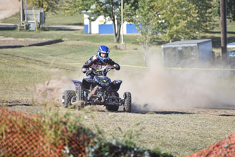 Democrat photo/Garrett Fuller — A dust cloud forms behind Wyatt Russell on Saturday as he speeds through the Russellville Lions Club's expanded ATV rodeo course.