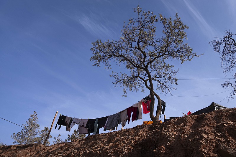 Laundry belonging to people who were displaced by the earthquake is put out against a tree in Ouirgane, outside Marrakech, Saturday, Oct. 7, 2023. Villagers in hard-hit regions are weighing how to best rebuild as Moroccan authorities begin to providing rehousing funds to those whose homes were destroyed by last month's earthquake. (AP Photo/Mosa'ab Elshamy)