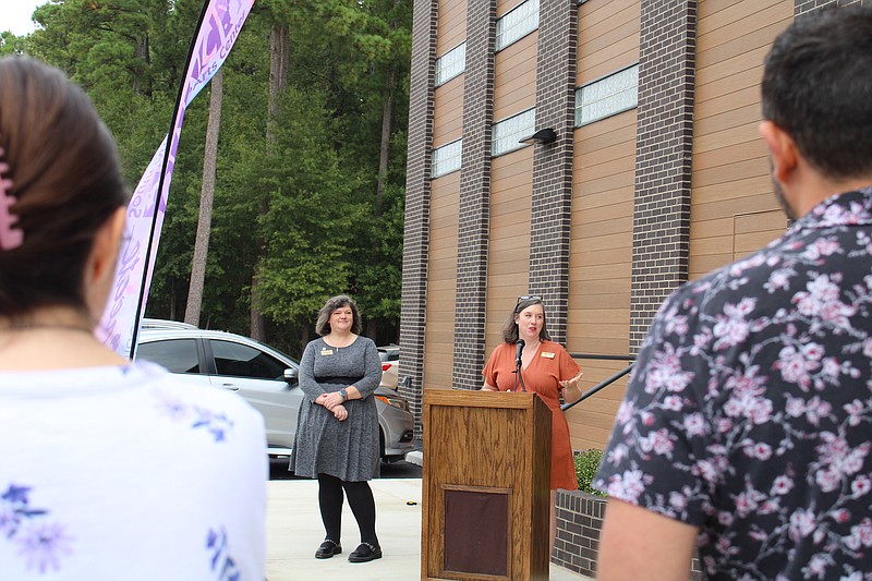 Laura Allen, executive director of the South Arkansas Arts Center, talks about the facility renovations the nonprofit has made during a grand unveiling of the changes on Thursday morning, as SAAC volunteer Karen Hicks looks on. (Caitlan Butler/News-Times)