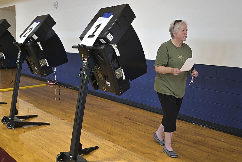 Nancy Bryant of Springdale finishes voting May 9 during a special election at the Archer Learning Center in Springdale. 
(File Photo/NWA Democrat-Gazette/Charlie Kaijo)