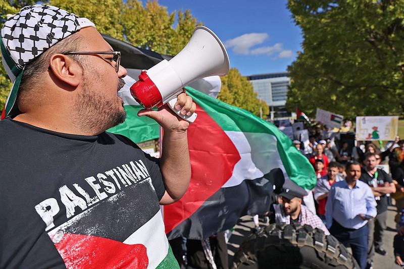 Ibrahim Abu Masrah leads demonstrators marching from the Clinton Presidential Library to downtown Little Rock in support of the Palestinian people Saturday, Oct. 14, 2023. The demonstration was in response to developments in the Middle East after last week's attack by Hamas militants into Israel which has now laid seige to the Gaza Strip trapping civilians in a warzone. (Arkansas Democrat-Gazette/Colin Murphey)