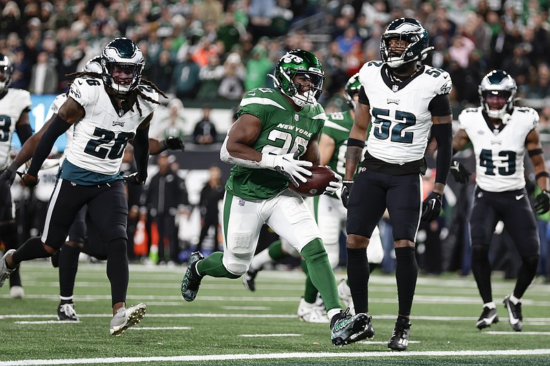 New York Jets' Breece Hall, center, scores a touchdown during the second half of an NFL football game against the Philadelphia Eagles, Sunday, Oct. 15, 2023, in East Rutherford, N.J. (AP Photo/Adam Hunger)