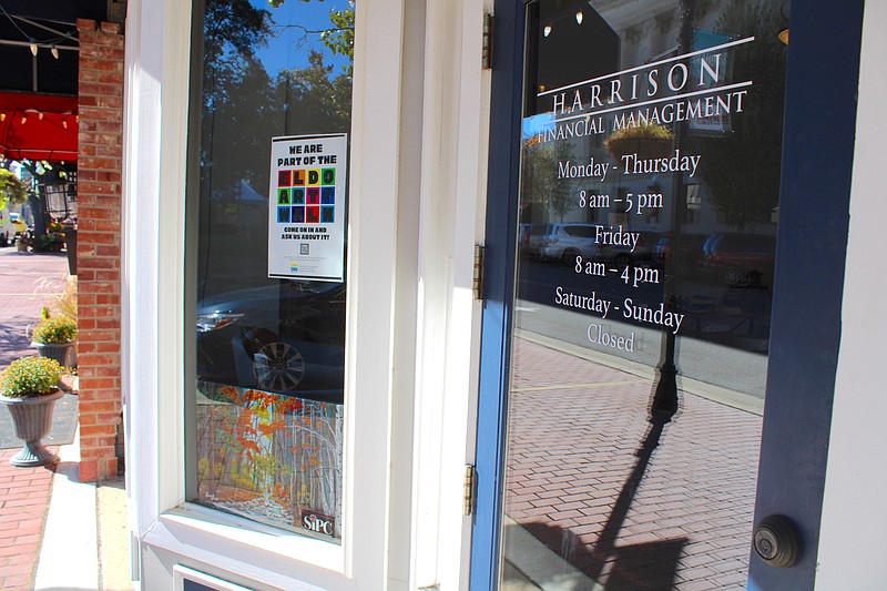 A painting by local artist Fadil Ismajli sits in the window of Harrison Financial Management as part of the Downtown Business Association's inaugural El Dorado Art Walk, which started Wednesday at 12 downtown businesses. (Caitlan Butler/News-Times)