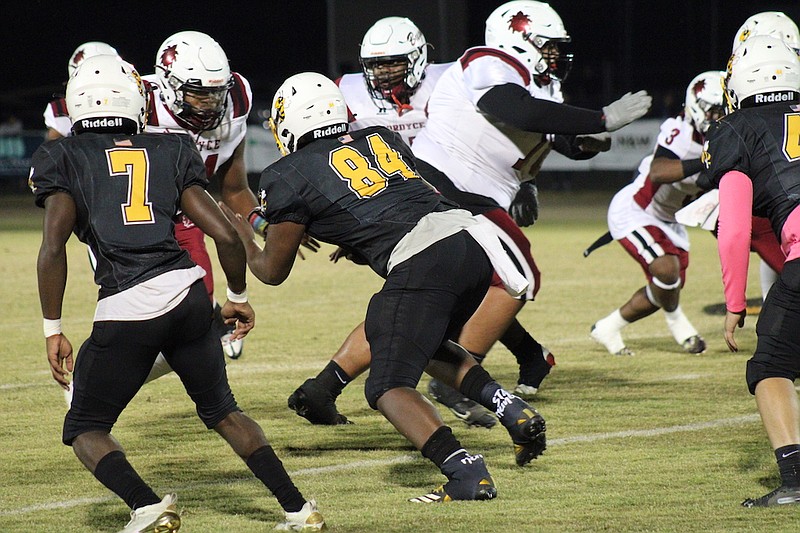 Photo By: Michael Hanich
Harmony Grove defensive end Quinton Jones attacks the offensive line of Fordyce last season.