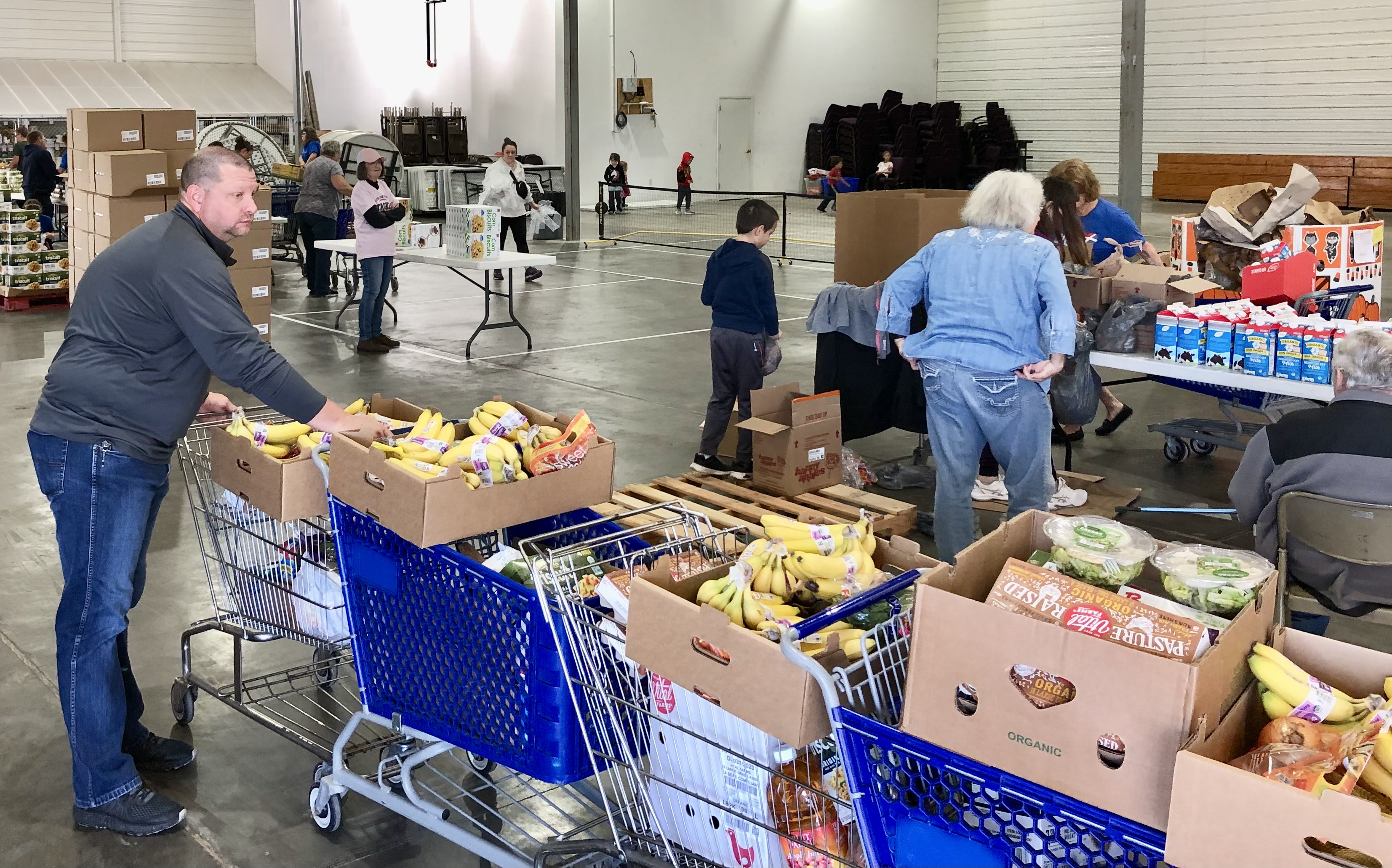 Families line up at Capital West Christian Church food pantry ...