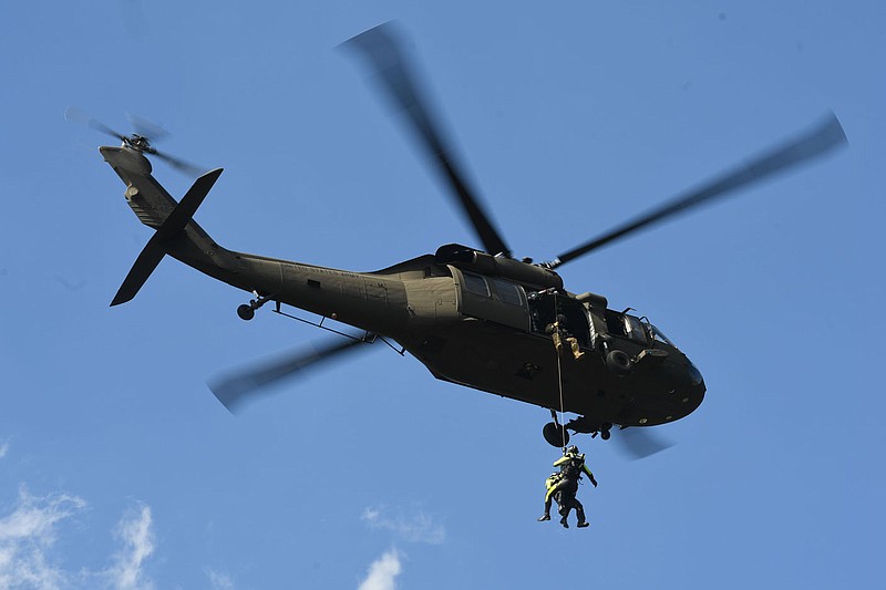Firefighters with the Arkansas Helicopter Rescue Team are lifted Wednesday, Oct. 11, 2023, into a Arkansas Air National Guard Sikorsky UH-60 Black Hawk helicopter during urban search and rescue training at Lake Sequoyah in Fayetteville. The team, which is managed by the Washington County Department of Emergency Management and the Arkansas Department of Emergency Management, practiced different methods of extraction from the water. Visit nwaonline.com/photo for today's photo gallery.
(NWA Democrat-Gazette/Andy Shupe)