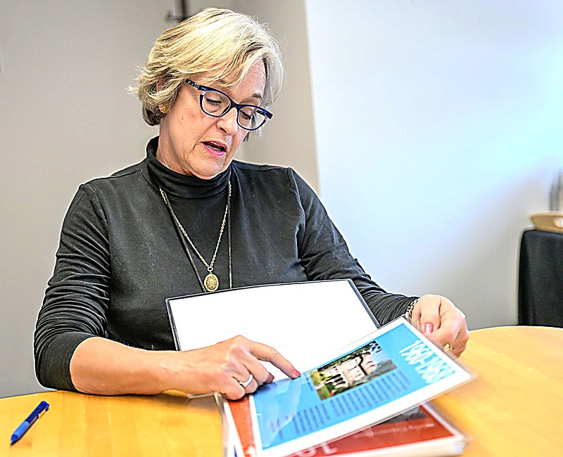 Julie Moncrief shows pamphlets detailing the history of the Fort Smith Regional Art Museum on Tuesday at the museum. The museum will have a celebration dedicating its Heritage Time Capsule on Dec. 9 to mark being an art leader in the community for 75 years. The deadline for submitting items is Nov. 24. Visit nwaonline.com/photo for todays photo gallery.

(River Valley Democrat-Gazette/Caleb Grieger)