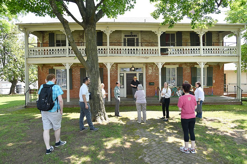 Members of the Fayetteville Advertising and Promotion Commission listen to a presentation May 22 during a tour of the new Folk School of Fayetteville in the historic Walker-Stone House in downtown Fayetteville. The city's Advertising and Promotion Commission in February agreed to lease the historic home to the people behind Fayetteville Roots to use as a school providing educational musical community programs, called Folk School of Fayetteville.

(File Photo/NWA Democrat-Gazette/Andy Shupe)