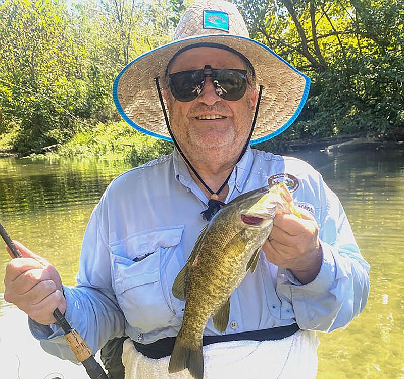 Jim Harris shows a smallmouth bass he caught from a stream in the Ouachita Mountains.
(Courtesy photo)