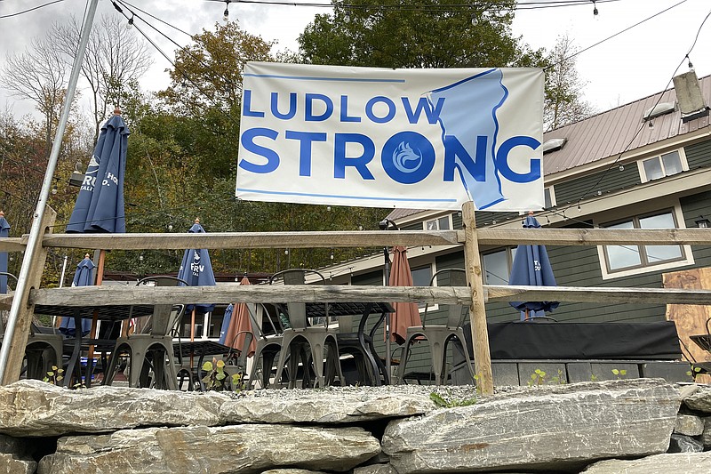 A "Ludlow Strong" sign hangs outside a restaurant, in Ludlow, Vt., Thursday, Oct. 19, 2023, three months after severe flooding hit the ski town. As winter approaches and the fall tourism season lingers, Ludlow businesses who lost out on summer tourism want to get the word out that they are open, even though a handful are still in the throes of rebuilding. (AP Photo/Lisa Rathke)