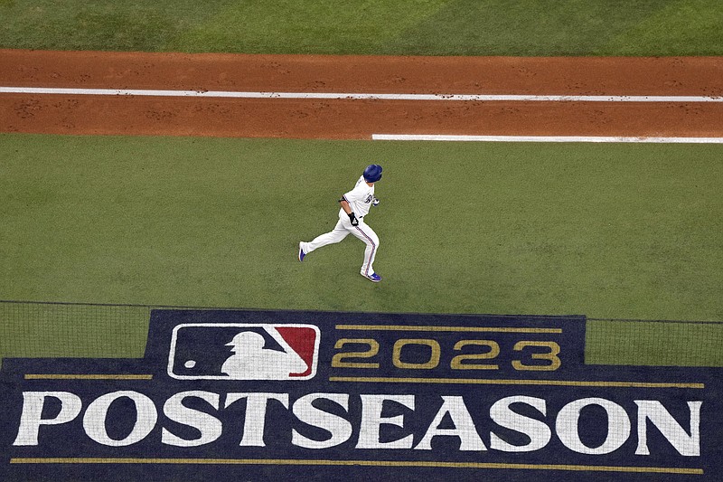 Texas Rangers' Corey Seager watches his home run against the Houston Astros during the third inning in Game 4 of the baseball American League Championship Series Thursday, Oct. 19, 2023, in Arlington, Texas. (AP Photo/Julio Cortez)