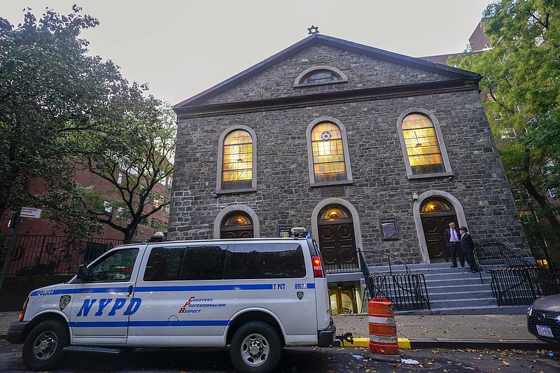 An New York Police Department patrol car is parked outside a synagogue Saturday, Oct. 7, 2023, on the Lower East Side of Manhattan. (AP Photo/Mary Altaffer)