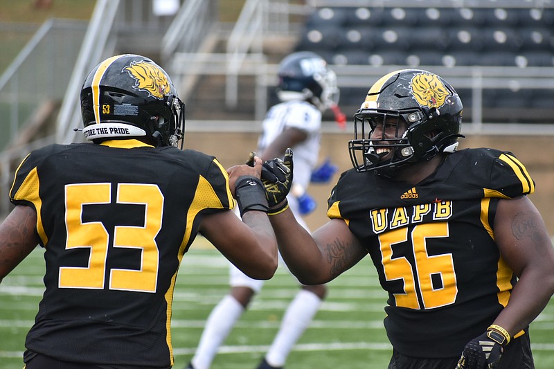 UAPB edge rushers Khalil Arnold (left) and Elijah Jenkins (right) share a fist bump after a play during an Oct. 28 football game against Jackson State at Simmons Bank Field. (Pine Bluff Commercial/I.C. Murrell)
