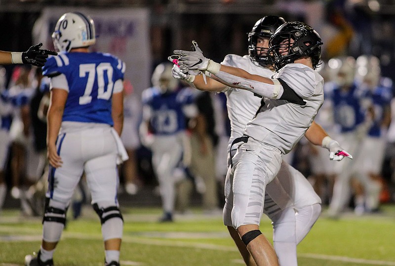 Bentonville's Ben Pearson (right) celebrates getting a sack with teammates against Rogers during an Oct. 6 game at Whitey Smith Stadium in Rogers. The Tigers are at Bentonville West on Friday, with the winner to earn the No. 2 seed in the 7A-West Conference.
(Special to NWA Democrat-Gazette/Brent Soule)