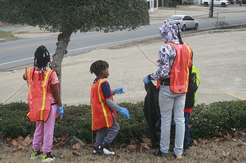 Local residents clean the streets in this News-Times file photo. A community cleanup for Ward 4 is scheduled Saturday, and slots remain open for volunteer incentives.