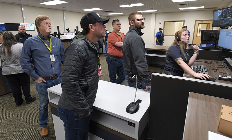Kaitlyn Stevens (right), a dispatcher with the Washington County Sheriffâ€™s Office, speaks Tuesday, Oct. 31, 2023, with radio technicians as the county transitions to a new radio system at the county detention center in Fayetteville. The new radio system connects the countyâ€™s representatives with the center as they travel across the state and allows seamless communications with most area agencies. Visit nwaonline.com/photo for today's photo gallery.
(NWA Democrat-Gazette/Andy Shupe)
