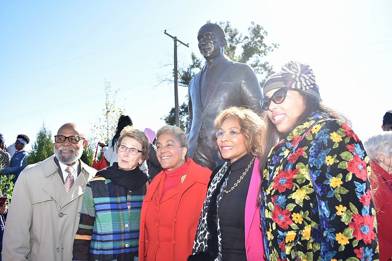 Calvin Johnson (left), Lynne Walton, Linda Johnson Rice, Susan Holley Williams and Alexa Rice pose in front of the John H. Johnson statue Williams sculpted. (Pine Bluff Commercial/I.C. Murrell)