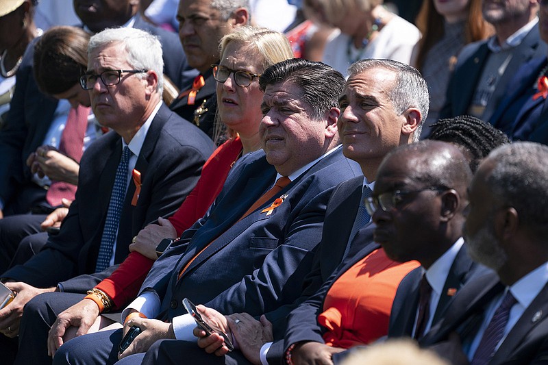Gov. J.B. Pritzker, D-Ill., listens as President Joe Biden speaks during an event to celebrate the passage of the "Bipartisan Safer Communities Act," a law meant to reduce gun violence, on the South Lawn of the White House, Monday, July 11, 2022, in Washington. (AP Photo/Evan Vucci)