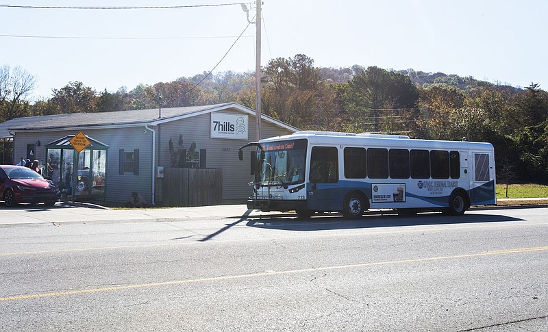 An Ozark Regional Transit bus makes a stop Friday at 7 Hills Homeless Center in Fayetteville. Regional Transit Providers and Regional Planners are looking at reinstituting fares for on-demand transit and possibly changing the allocation of federal transit money the region receives that is split between Ozark Regional Transit and University of Arkansas Razorback Transit. Visit nwaonline.com/photo for today's photo gallery.
(NWA Democrat-Gazette/J.T. Wampler)