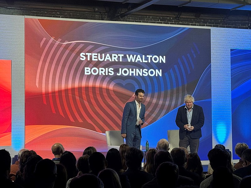 Steuart Walton and Boris Johnson, former prime minister of the United Kingdom, share the stage Wednesday, Nov. 8, 2023, during the Heartland Summit in Bentonville.
(NWA Democrat-Gazette/DOUG THOMPSON)