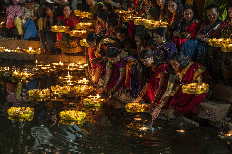 FILE - Hindu women light oil lamps at the Banganga pond as they celebrate Dev Diwali festival in Mumbai, India, Nov. 7, 2022. Diwali is the most important festival of the year in India and for Hindus in particular. It is celebrated across faiths by more than a billion people in the world&#x2019;s most populous nation and the diaspora. This year, Diwali begins Friday, Nov. 10, 2023, and the festival will be observed on Sunday, Nov. 12. (AP Photo/Rafiq Maqbool, File)