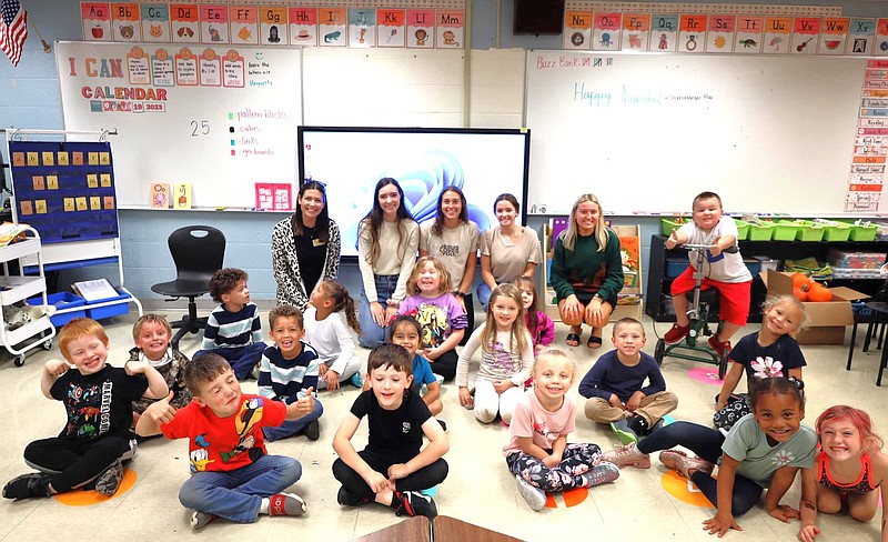 Submitted photo
Members of the Rotaract Club at William Woods University visit kindergarten students at Bush Elementary School. Back row, left to right: Haley Gilmore, Rotaract sponsor; members Shannon Jones, Crystal Ruden and Caroline McCurren; and teacher, Sarah Kasubke.