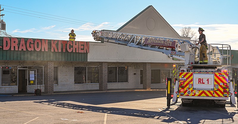 Julie Smith/News Tribune photo: 
Smoke is forced out the front door of Dragon Kitchen restaurant Monday, Nov. 13, 2023, after firefighters placed fans in doorways. Jefferson City firefighters responded to a kitchen fire at the Missouri Boulevard restaurant.