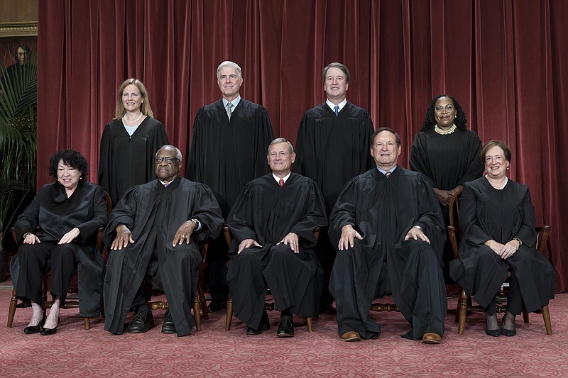 FILE - Members of the Supreme Court sit for a new group portrait following the addition of Associate Justice Ketanji Brown Jackson, at the Supreme Court building in Washington, Oct. 7, 2022. Bottom row, from left, Justice Sonia Sotomayor, Justice Clarence Thomas, Chief Justice John Roberts, Justice Samuel Alito, and Justice Elena Kagan. Top row, from left, Justice Amy Coney Barrett, Justice Neil Gorsuch, Justice Brett Kavanaugh, and Justice Ketanji Brown Jackson. The Supreme Court is adopting its first code of ethics, in the face of sustained criticism over undisclosed trips and gifts from wealthy benefactors to some justices. The policy was issued by the court Monday.  (AP Photo/J. Scott Applewhite, File)