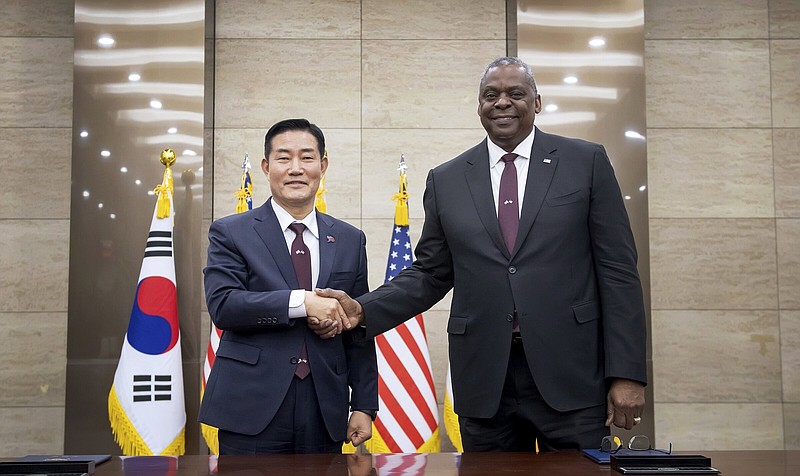 In this photo provided by the South Korea Defense Ministry, U.S. Secretary of Defense Lloyd Austin, right, and his South Korean counterpart Shin Won-sik shake hands for a photo during a signing ceremony of the 55th Security Consultative Meeting (SCM) at the defense ministry, in Seoul, South Korea, Monday, Nov. 13, 2023. (South Korea Defense Ministry via AP)