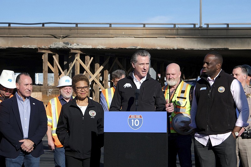 California Gov. Gavin Newsom, with Los Angeles Mayor Karen Bass, left, speaks during a news conference about repairs for a stretch of Interstate 10, Tuesday morning Nov. 14, 2023, in Los Angeles. It will take at least three weeks to repair the Los Angeles freeway damaged in an arson fire, the Newsom said Tuesday, leaving the city already accustomed to soul-crushing traffic without part of a vital artery that serves hundreds of thousands of people daily. (Dean Musgrove/The Orange County Register via AP)