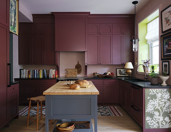 Pastel blue fitted units with granite worktops in terracotta