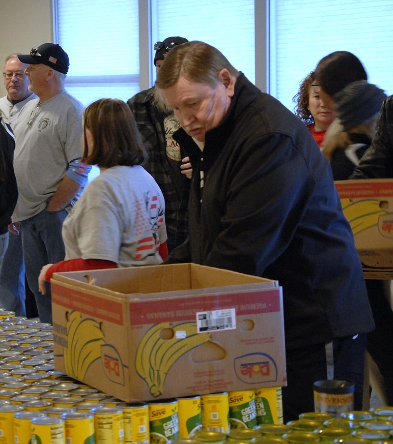 Miriam Bazylewicz/News Tribune photo: 
Dan Orf picks up green bean cans to fill Thanksgiving meal boxes Saturday, Nov. 18, 2023, at the Elks Lodge in Jefferson City.