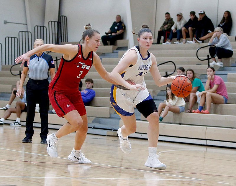 Photo courtesy of Southeastern University

John Browns Tarrah Stephens (right) dribbles the ball as Southeasterns Anja Knoflach guards Nov. 18 at The Furnace on the campus of Southeastern University in Lakeland, Fla.