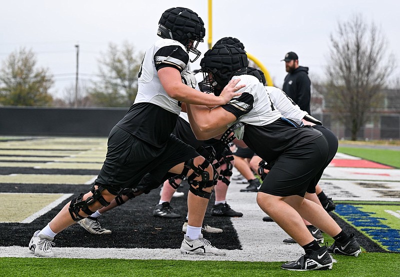 Bentonville linemen run drills on Tuesday, Nov. 21, 2023, at Tiger Stadium in Bentonville. The Tigers are one of a few teams left in the state who will be practicing today on Thanksgiving. Visit nwaonline.com/photo for today's photo gallery. (NWA Democrat-Gazette/Caleb Grieger)
