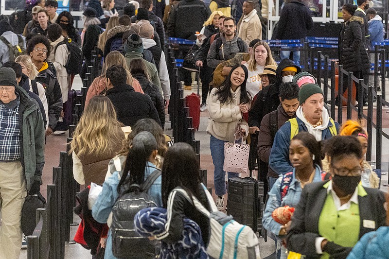 Early morning travelers make their way through the security line at Hartsfield-Jackson International Airport on Saturday, Dec. 24, 2022. (Steve Schaefer/Atlanta Journal-Constitution/TNS)