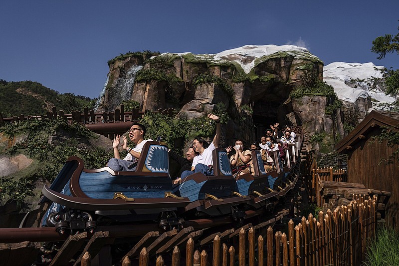 Visitors ride the Wandering Oaken's Sliding Sleighs roller coaster ride after opening ceremony of the World of Frozen themed area at Disneyland Resort in Hong Kong, Monday, Nov. 20, 2023. (AP Photo/Louise Delmotte)