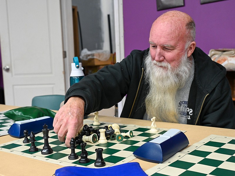 Julie Smith/News Tribune
Tom Lawler sets up the chess board Tuesday while taking part in a lesson at Building Community Bridges. The instruction is provided by BCB and anyone who chooses can take part in the activity, which is taught by Tim Campbell each Tuesday at the center on East Ashley Street. In addition to playing at BCB, Lawler has joined the Missouri Chess Association and the United States Chess Federation.