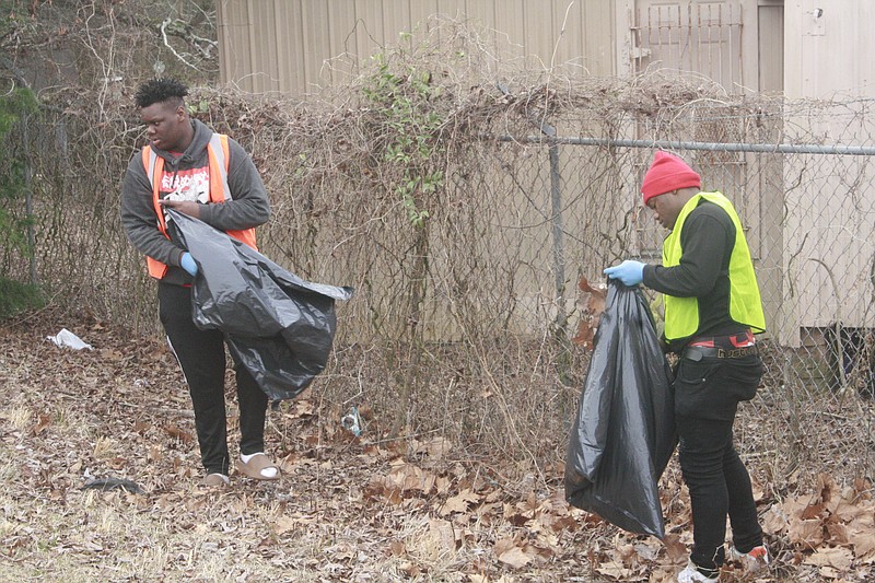 Local residents are seen cleaning neighborhood trash in this News-Times file photo. Keep El Dorado Beautiful is wrapping up a successful year of trying to remove litter in the community.