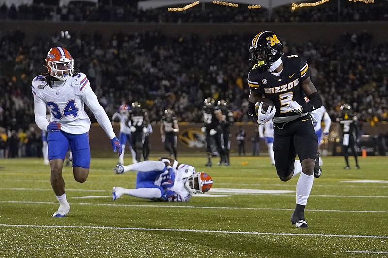 Missouri wide receiver Luther Burden III (3) runs with the ball after catching a pass as Florida linebacker Mannie Nunnery (34) defends during the second half of an NCAA college football game Saturday, Nov. 18, 2023, in Columbia, Mo. Missouri won 33-31. (AP Photo/Jeff Roberson)