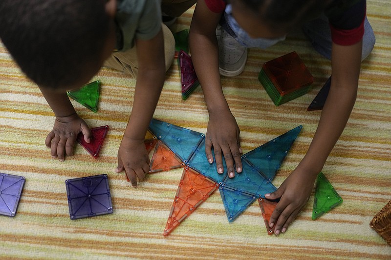 Children work on a puzzle during a preschool class at the Life Learning Center - Head Start, in Cincinnati, Tuesday, Nov. 21, 2023. A new plan from the Biden administration could significantly increase salaries for hundreds of low-paid early childhood teachers caring for the country's poorest children but might also force some centers to cut enrollment. (AP Photo/Carolyn Kaster)