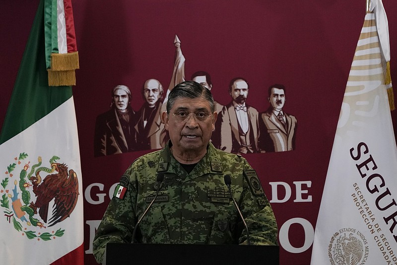 FILE - Mexican Defense Secretary Luis Cresencio Sandoval announces the arrest of Ovidio during a press conference in Mexico City, on Jan. 5, 2023. The U.S. government thanked Mexico for arresting a hyper violent alleged Sinaloa cartel security chief, but according to details released Friday, Nov. 24, 2023 the arrest of suspect Nestor Isidro Pérez Salas this week may have been highly personal for the Mexican army. Sandoval said Pérez Salas had ordered a 2019 attack on an unguarded apartment complex where soldiers families lived. (AP Photo/Eduardo Verdugo, File)