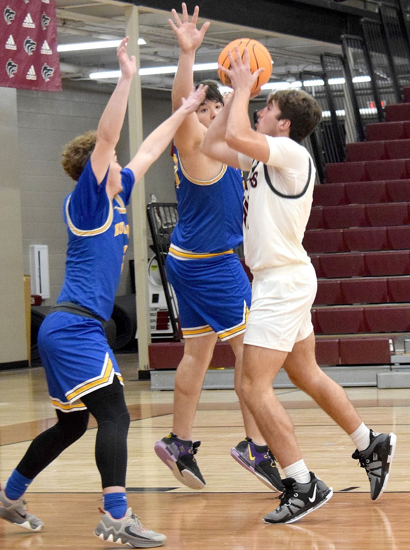 Mike Eckels/Special to the Eagle Observer
Bulldog Jackson Montano (left) and brother Brandon use their bodies to block a Wolves' shooting attempt during the second quarter of the Lincoln-Decatur varsity boys basketball contest in Lincoln on Nov. 20. The Wolves took the win over the Bulldogs, 54-25.