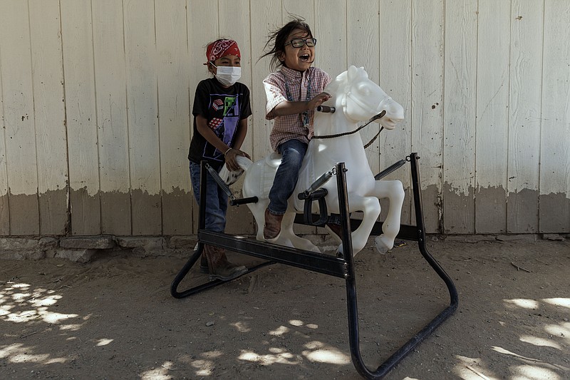 Hataałii Tiisyatonii "HT" Begay, 5, rides a toy horse next to his brother Hastiin, 7, at the family ranch on the Navajo Nation. Adriana Zehbrauskas for The Washington Post