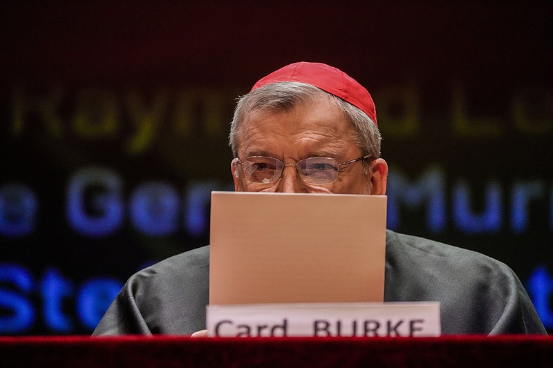 FILE - Cardinal Raymond Burke attends the conference "The synodal Babel" in a theater near the Vatican on Oct. 3, 2023, after a letter he signed with others and containing questions to Pope Francis about the upcoming synod of bishops was made public. Pope Francis has taken measures to punish one of his highest-ranking critics, Cardinal Raymond Burke, by yanking his right to a Vatican apartment and salary in the second such radical action against a conservative American prelate this month. (AP Photo/Gregorio Borgia, File)